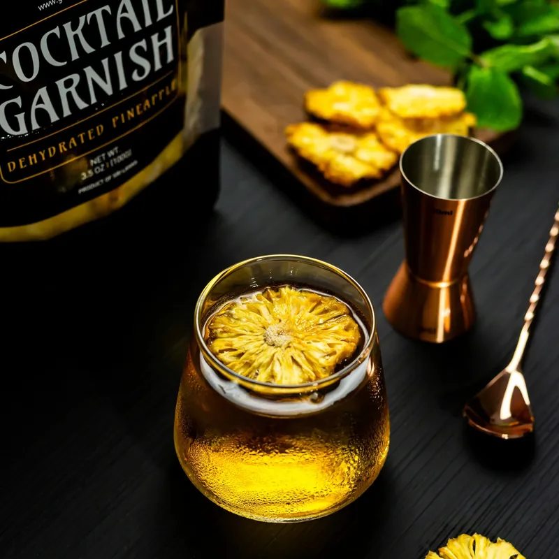 Whisky glass topped with a dried pineapple flower